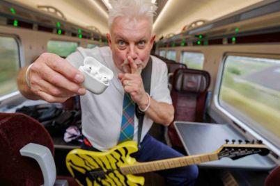 Robb-Weir-onboard-LNER-train-with-guitar-calling-for-quiet_cropped-scaled-1.jpg